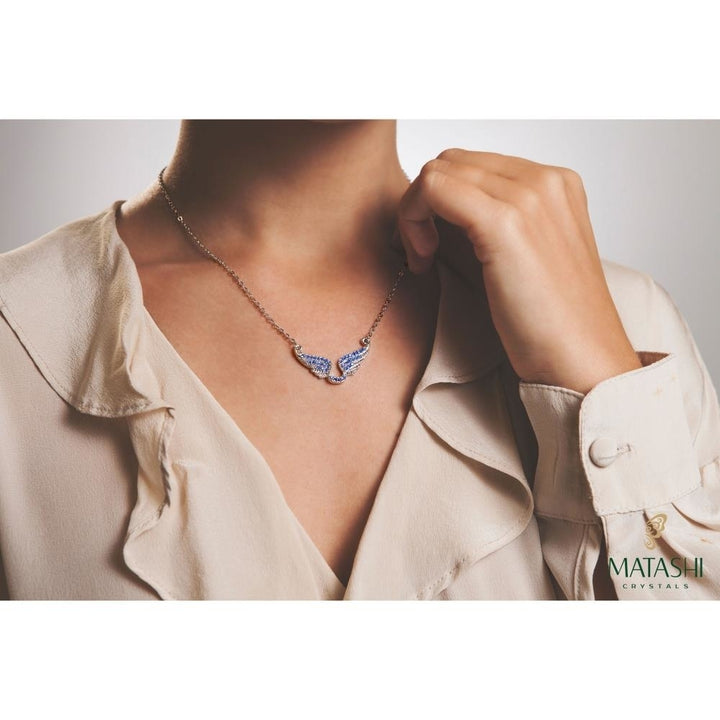 Rhodium Plated Necklace with Outspread Angel Wings Design with a 16" Extendable Chain and fine Ocean Blue Crystals by Image 4