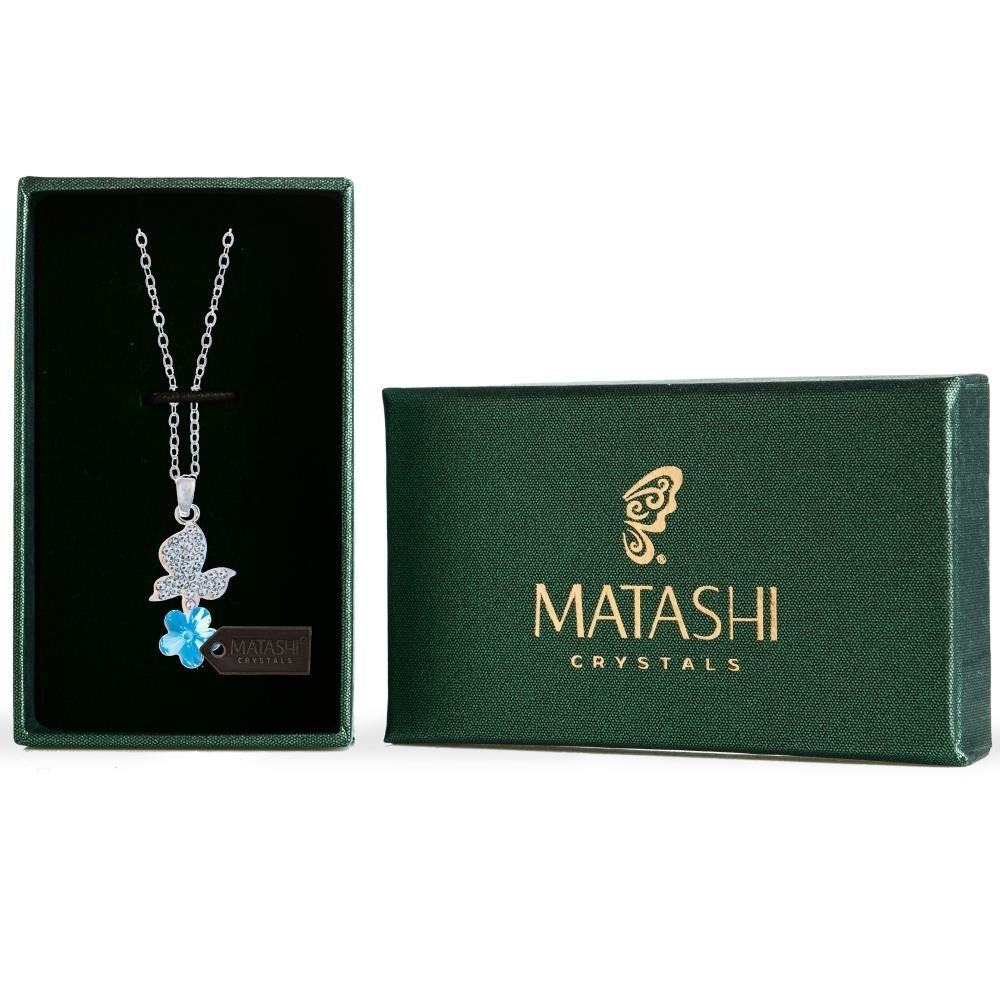 Rhodium Plated Necklace with Butterfly Alighting on a Flower Design with a 16" Extendable Chain and fine Blue Crystals Image 1