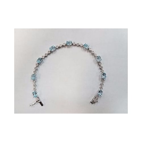 9 CARAT OVAL BLUE TOPAZ AND DIAMOND BRACELET IN RHODIUM PLATED BRASS Image 2