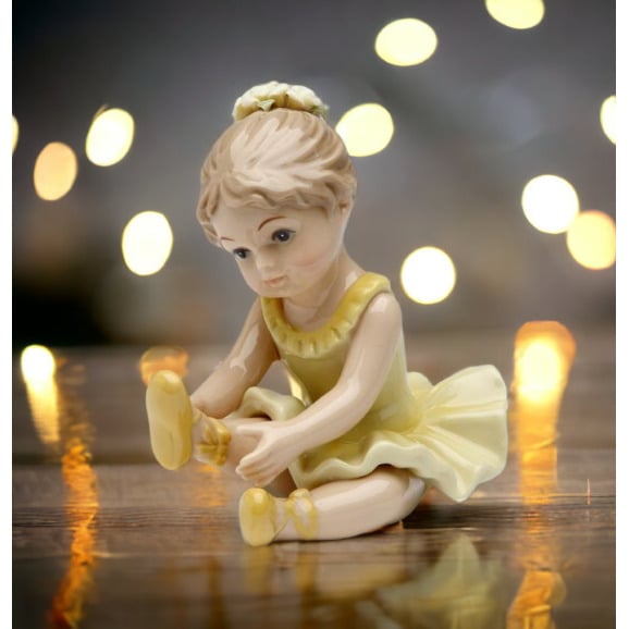 Ceramic Ballerina Figurine Yellow Stretching Leg Image 1